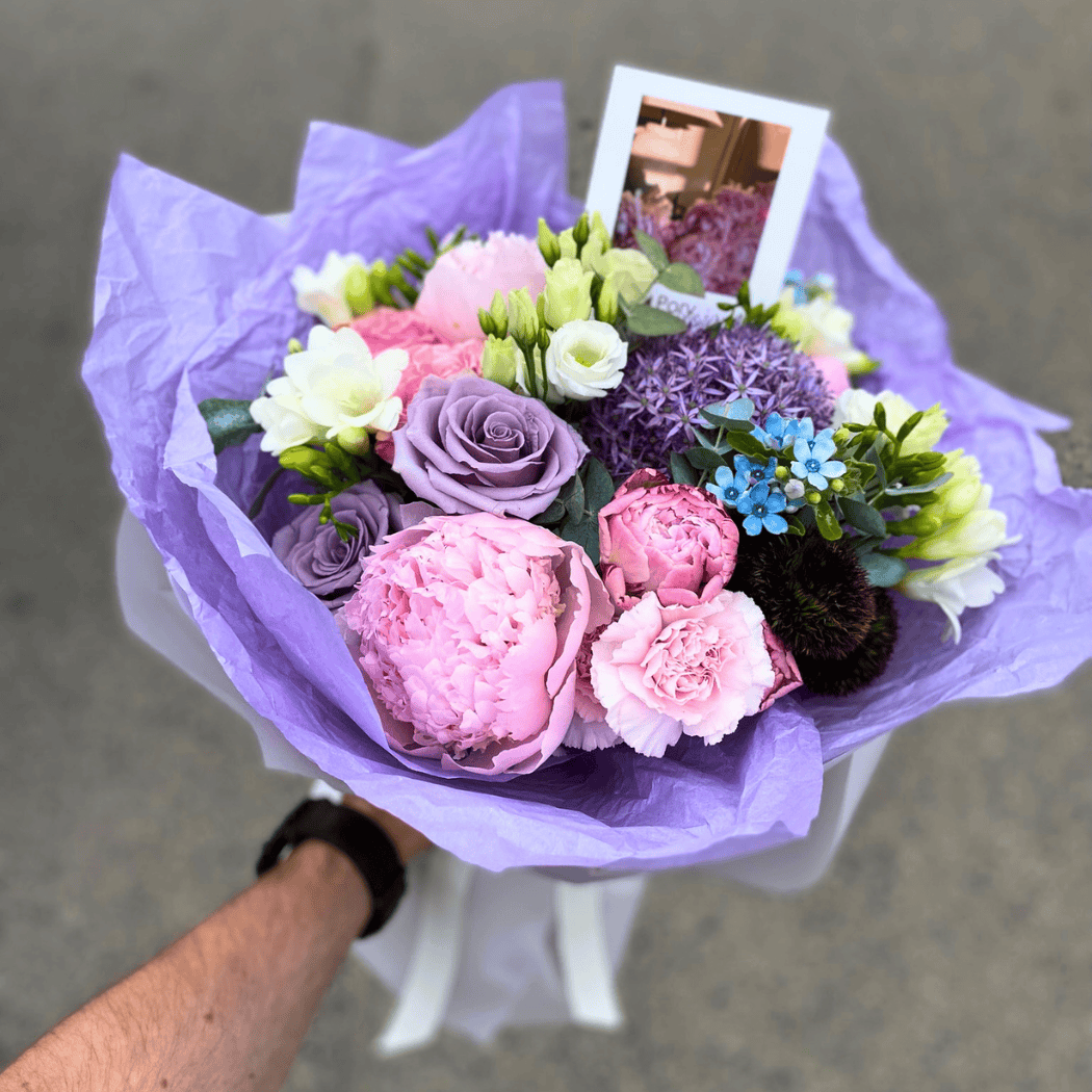 bukiet wiosenny z piwonią, różą, czosnkiem, oxypetalum, frezją w fioletowym papierze